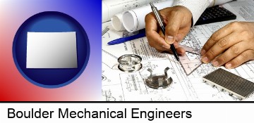 a mechanical engineer working on a blueprint in Boulder, CO