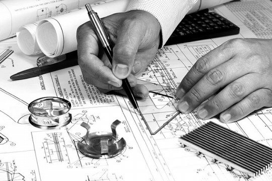 a mechanical engineer working on a blueprint